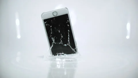 Smart phone device falling and splashing on white background Video stock 144692762