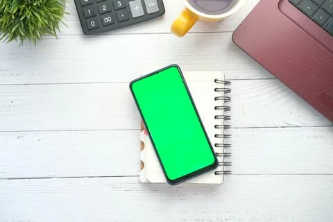 Smart phone with empty screen, laptop on wooden background Stock Photos