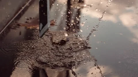 Smart phone falling and splashing and smashing in extreme slow motion Stock Footage 141699760