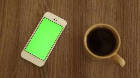 Smart Phone with Green Screen and Cup of Coffee on Table Stock Footage 338122073