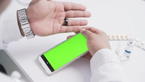 Smart phone with green screen in doctor's hands Stock Footage 189391497