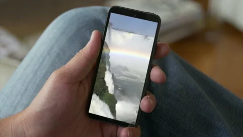 Smart Phone held by hands. Falls Cinemagraph. Close up. Stock Footage 131243776
