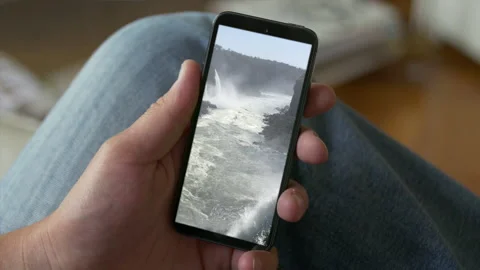Smart Phone held by hands. Falls Cinemagraph. Close up. Stock Footage 131243904