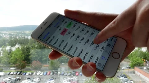 Smart Phone held by hands with global exchange rate Video stock 64256719