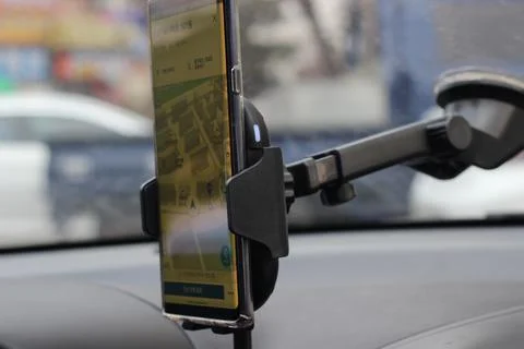 Smart phone holder attached to windscreen of car Stock Photos