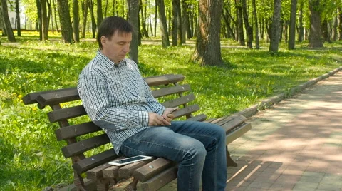 Smart phone man calling on mobile phone in park Stock Footage 63150207