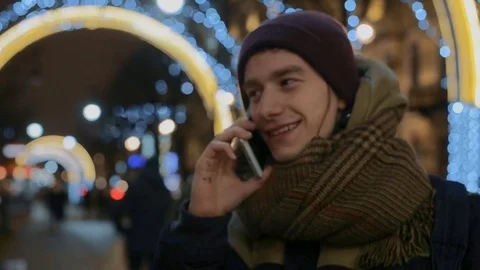 Smart phone man calling on mobile phone at night in city. Handsome young Stock Footage 71389741
