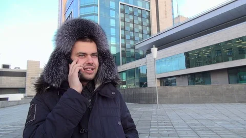 Smart phone man calling on mobile phone at night in city. Handsome young Stock Footage 73727991