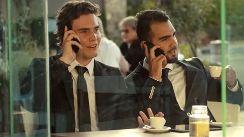 Smart phone men calling on mobile phone at coffee cafe. Handsome young multi-eth Stock Footage 199633971