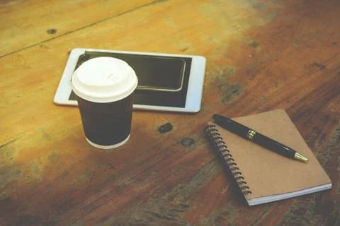 Smart phone, tablet, note book, pen and coffee Фото