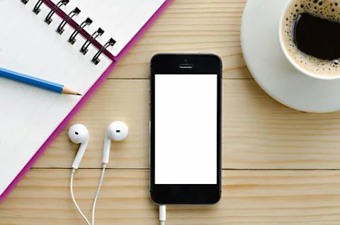 Smart phone with white blank empty screen and coffee and notebook and pencil Stock Photos