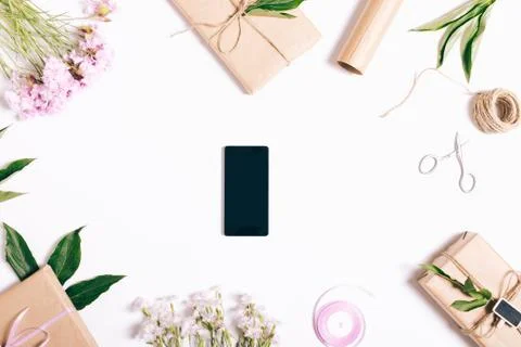 Smart phone on white table with decorations Stock Photos