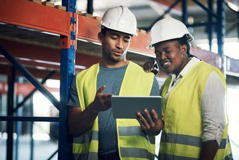 Smart planning makes for safe operations. two builders using a digital tablet Stock Photos
