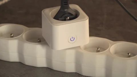 Smart plug with glowing blue power button connected to extension cord. cubi.. Stock Footage 333124152