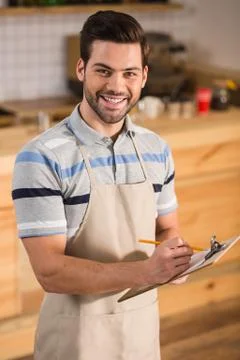 Smart positive waiter taking notes Stock Photos