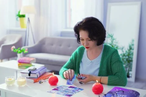 Smart professional fortune teller interpreting the meanings of cards Stock Photos
