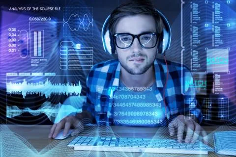 Smart programmer biting his lip while looking at the screen Stock-Fotos