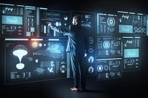 Smart programmer touching the screen while working with a futuristic computer Stock Photos