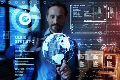 Smart programmer touching virtual planet while working with transparent screen Stock-Fotos