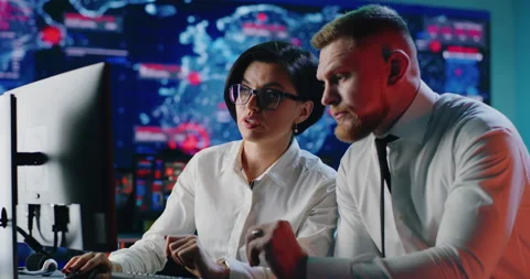 Smart programmers discussing data on computer Stock Footage 148242121