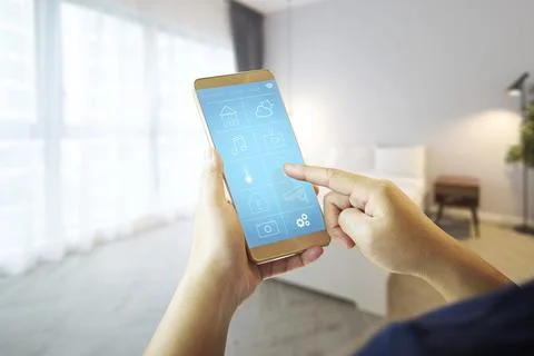 Smart Remote Home Control System Apps auf einem Handtelefon mit stumpfem Haus Stock Photos