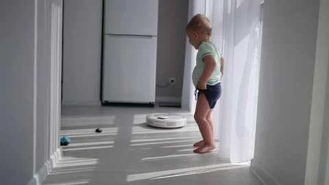 A smart robot cleans a vacuum cleaner on the floor Stock Footage 131650337