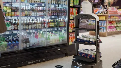 Smart robot walking in a supermarket Robot sells drinks in a supermarket Stock Footage 256581929