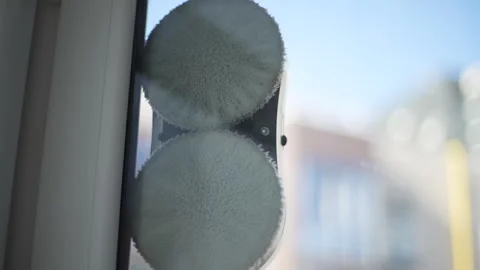 Smart robot window vacuum cleaner washing glass with round rags inside apartment Stock Footage 263734126