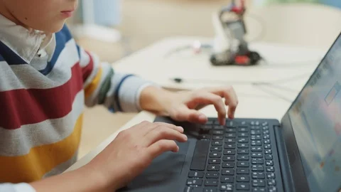 Smart Schoolboy Uses Laptop to Program Software for Robotics Engineering Class. Stock Footage 119560919