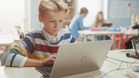 Smart Schoolboy Uses Laptop to Program Software for Robotics Engineering Class. Stock Footage 119561367