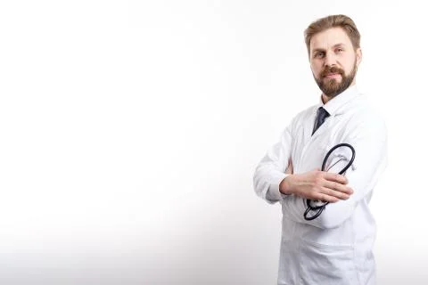 Smart Smiling Doctor Posing Half-turned With Stethoscope, Arms Crossed Stock Photos