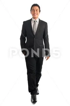 Smart Southeast Asian businessman walking Stock Photos