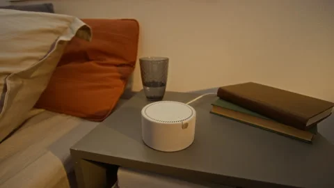 Smart Speaker Activating with Glowing Light on Bedside Table Stock Footage 340783243