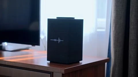 Smart speaker displaying equalizer on wooden cabinet Stock Photos