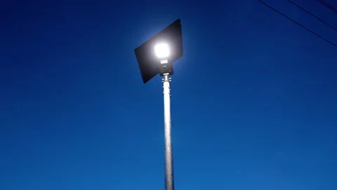 Smart street light with solar charging technology illuminated at night Stock Footage 318712876