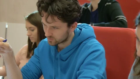 Smart student asks a question during university lecture in the auditorium Stock Footage 75556018