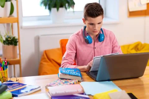 Smart student doing math homework sitting at the laptop Foto stock