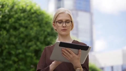 A smart student with glasses is looking for information for her report using a Stock Footage 159002203
