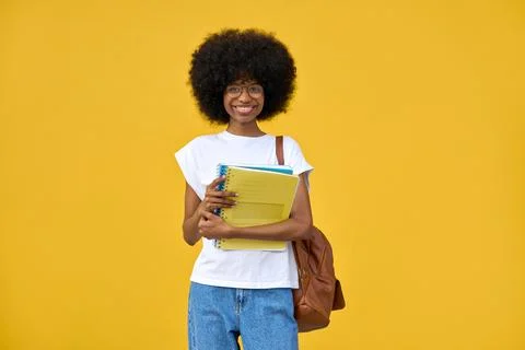 Smart student looking at camera on orange background with copy space. Stock Photos