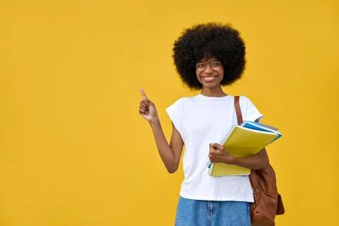 Smart student looking at camera on orange background with copy space. Stock Photos