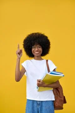 Smart student looking at camera on orange background with copy space. Foto stock