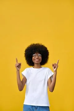 Smart student looking at camera on orange background with copy space. Stock Photos