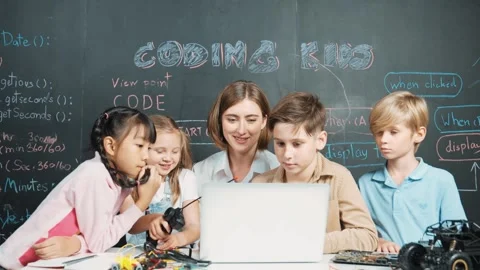 Smart teacher and diverse student looking at laptop at blackboard. Erudition. Stock Footage 264470181