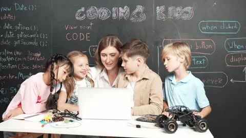 Smart teacher and diverse student looking at laptop at blackboard. Erudition. Stock Footage 265501296