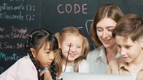 Smart teacher and diverse student looking at laptop at blackboard. Erudition. Stock Footage 273015591