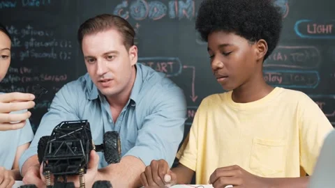 Smart teacher explain car model construction to diverse student. Edification Stock Footage 263957281