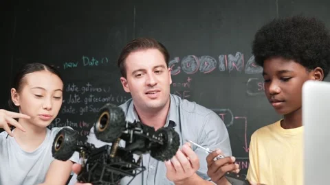 Smart teacher explain car model construction to diverse student. Edification Stock Footage 270207727