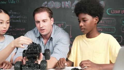 Smart teacher explain car model construction to diverse student. Edification Stock Footage 270914293