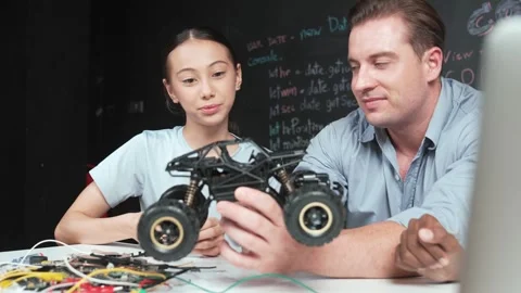 Smart teacher explain car model construction to diverse student. Edification Stock Footage 275087743