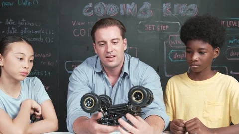 Smart teacher explain car model construction to diverse student. Edification Stock Footage 278063651